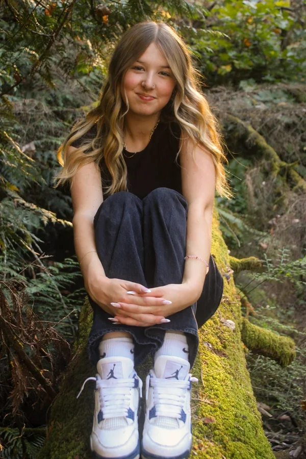 Close portrait of Lynden smiling while seated outdoors