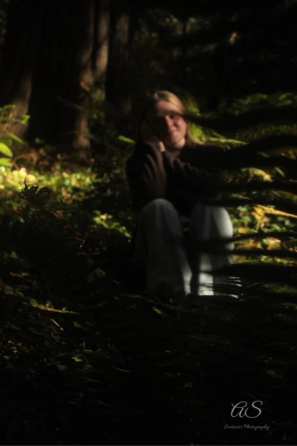 Young woman in a dark moody forest